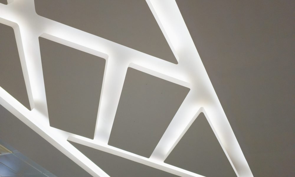 Suspended ceiling with halogen spots lamps and drywall construction in room