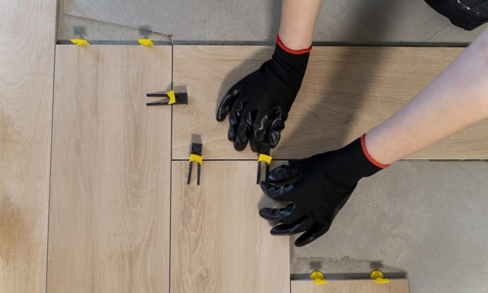 top-view-worker-tiling-floor